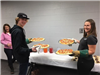 Young people serving up pizza