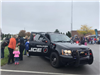 Participants check out a Walker police car