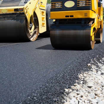 Closeup shot of paving equipment over new roadway