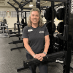 woman standing in front of fitness equipment
