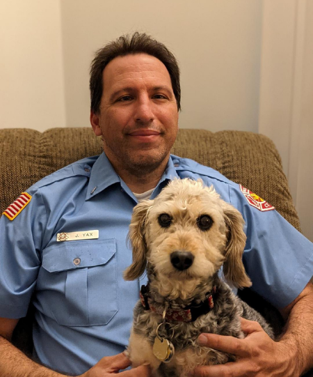 Firefighter with dog on his lap